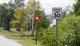 Figure 5. Example of vegetation obstructing pedestrian and driver view of the tracks at a passive crossing in Swanton, VT Image Credit: Volpe Center